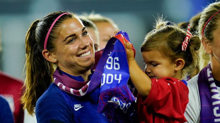 United States star Alex Morgan holds her daughter, Charlie. (AP/Julio Cortez)