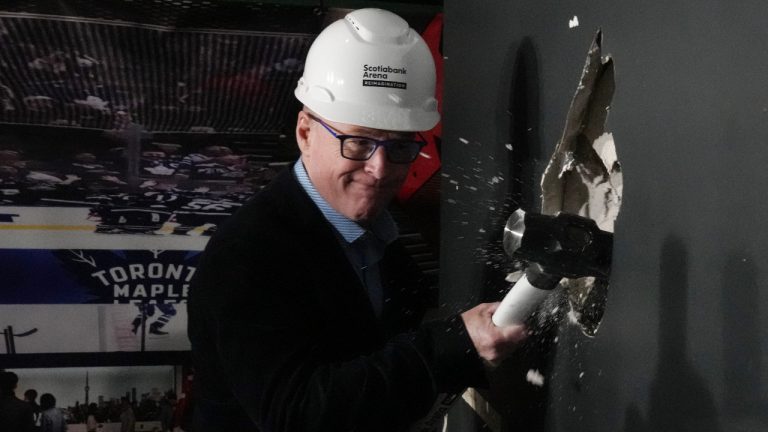 Keith Pelley, CEO of Maple Leaf Sports and Entertainment, swings a sledgehammer during a photo opportunity, as MLSE announces the second phase of Scotiabank Arena Reimagination project, in Toronto, on Tuesday, May 14, 2024. (Chris Young/CP)