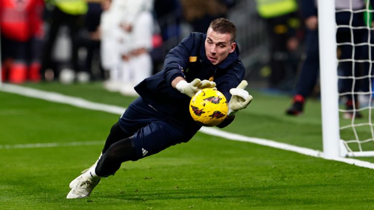 Real Madrid's goalkeeper Andriy Lunin saves the ball as he warms-up before the Spanish La Liga soccer match between Real Madrid and Villarreal at the Santiago Bernebeu stadium in Madrid, Spain, Sunday, Dec. 17, 2023. (Pablo Garcia/AP) 