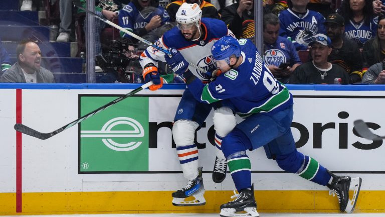 Vancouver Canucks' Nikita Zadorov, front right, checks Edmonton Oilers' Evander Kane during the second period in Game 5 of an NHL hockey Stanley Cup second-round playoff series, in Vancouver, on Thursday, May 16, 2024. THE CANADIAN PRESS/Darryl Dyck 