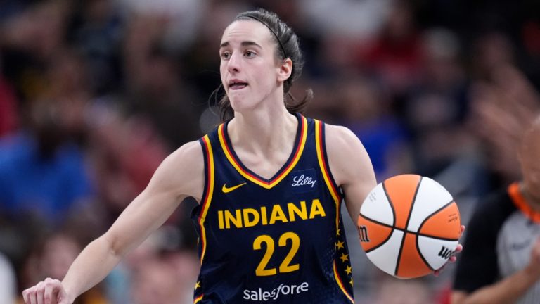 Indiana Fever guard Caitlin Clark (22) drives up court in the second half of a WNBA basketball game against the New York Liberty, Thursday, May 16, 2024, in Indianapolis. (Michael Conroy/AP) 