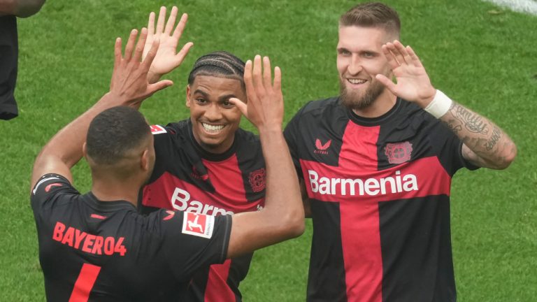 Leverkusen's Robert Andrich, right, celebrates with teammates after scoring his side's second goal during the German Bundesliga soccer match between Bayer Leverkusen and FC Augsburg at the BayArena in Leverkusen, Germany, Saturday, May 18, 2024. Bayer Leverkusen have won the Bundesliga title for the first time. (Michael Probst/AP) 