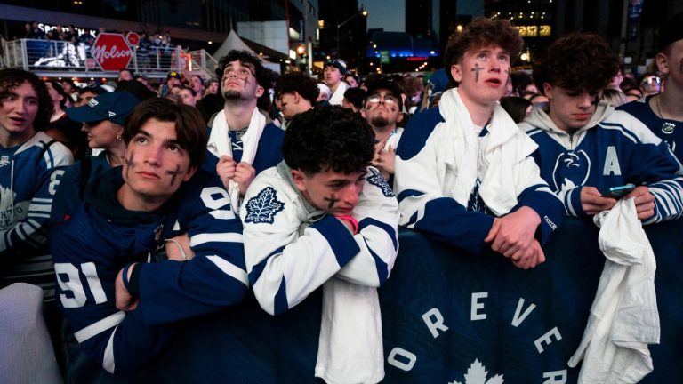 Fans watch the Toronto Maple Leafs play the Boston Bruins in game 6 of first-round NHL playoff series on a video screen outside Scotiabank Arena in Toronto on Thursday, May 2, 2024. (Arlyn McAdorey/CP Photo)