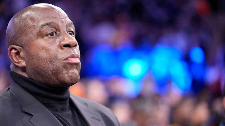 Magic Johnson watches players warm up before an NBA basketball game between the New York Knicks and the Los Angeles Lakers Saturday, Feb. 3, 2024, in New York. (AP Photo/Frank Franklin II)