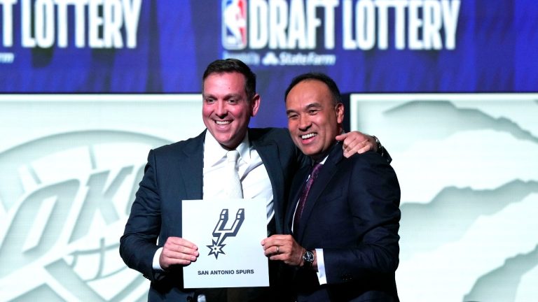 San Antonio Spurs managing partner Peter J. Holt, left, stands with NBA Deputy Commissioner Mark Tatum after Tatum announced that the Spurs won the first pick in the NBA draft, at the draft lottery in Chicago, Tuesday, May 16, 2023. (AP Photo/Nam Y. Huh)