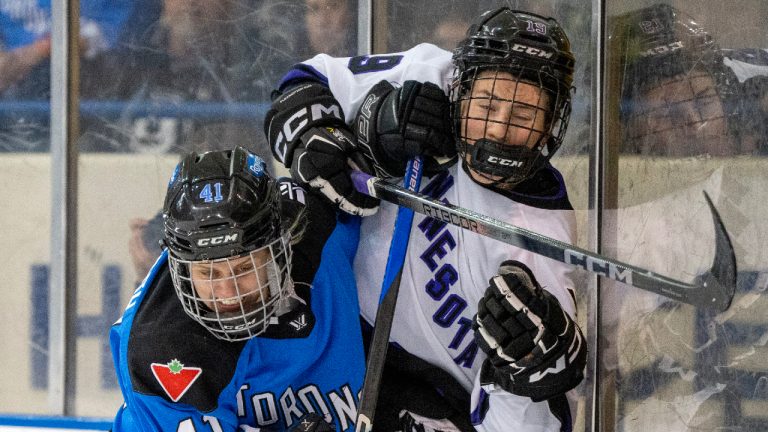 Toronto's Brittany Howard (41) drives Minnesota's Maggie Flaherty (19) into the boards during second period PWHL action in Toronto on Wednesday May 1, 2024. (Frank Gunn/CP)