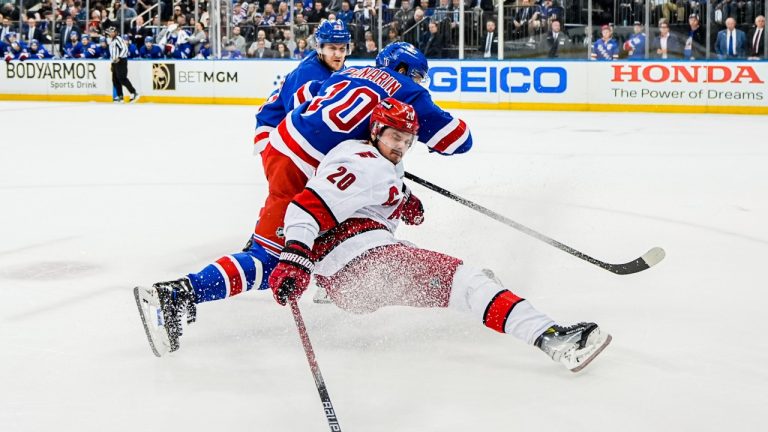 New York Rangers left wing Artemi Panarin (10) and Carolina Hurricanes center Sebastian Aho (20) fight for the puck as Rangers' left wing Chris Kreider (20) looks on during the first period in Game 2 of an NHL hockey Stanley Cup second-round playoff series, Tuesday, May 7, 2024, in New York. (Julia Nikhinson/AP)