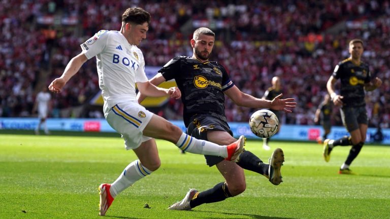 Leeds United's Daniel James, left, and Southampton's Jack Stephens battle for the ball during the Championship play-off final between Leeds United and Southampton at Wembley Stadium, London, Sunday May 26, 2024. (John Walton/PA via AP)