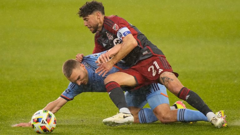 Toronto FC midfielder Jonathan Osorio (21) forces New York City midfielder James Sands (6) into the turf during first half MLS action in Toronto, Saturday, May 11, 2024. (Frank Gunn/CP)