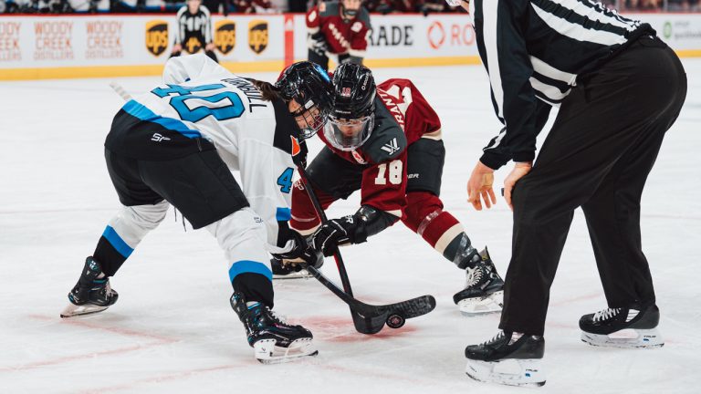 Toronto captain Blayre Turnbull, left, faces off against Montreal's Mikyla Grant-Mentis. Toronto can clinch the PWHL's No. 1 seed Wednesday night against Minnesota. (Photo by Arianne Bergeron/PWHL)