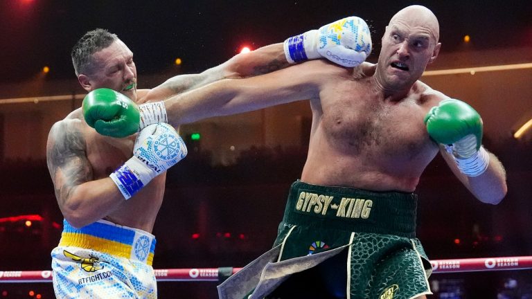 Britain’s Tyson Fury, right, and Ukraine’s Oleksandr Usyk exchange blows during their undisputed heavyweight world championship boxing fight at the Kingdom Arena in Riyadh, Saudi Arabia, Sunday, May 19, 2024. (Nick Potts/PA via AP)