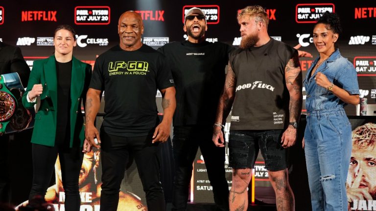 Katie Taylor, Mike Tyson, Jake Paul and Amanda Serrano, from left, pose for photos during a news conference promoting their upcoming boxing bouts. (Sam Hodde/AP)