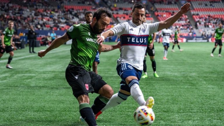 Cavalry FC's Sergio Camargo and Vancouver Whitecaps' Luís Martins compete for ball possession during the first half of a Canadian Championship quarterfinal soccer match, in Vancouver, on Tuesday, May 21, 2024. (Ethan Cairns/CP Photo)
