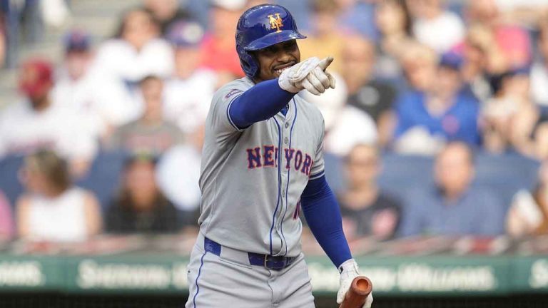 New York Mets' Francisco Lindor gestures to the Cleveland Guardians' dugout as he comes up to bat in the first inning of a baseball game. (Sue Ogrocki/AP)