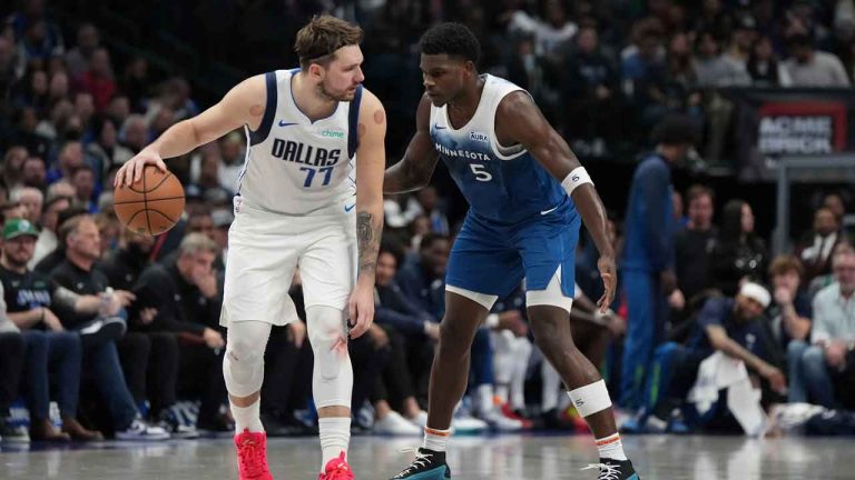 Dallas Mavericks guard Luka Doncic (77) dribbles against Minnesota Timberwolves guard Anthony Edwards (5) during the second half of an NBA basketball game. (Jeffrey McWhorter/AP)