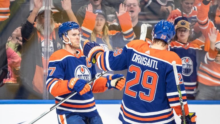 Edmonton Oilers' Connor McDavid (97) and Leon Draisaitl (29) celebrate an overtime goal against the Vancouver Canucks during overtime NHL pre season action in Edmonton, Wednesday, Sept. 27, 2023. (Jason Franson/CP)