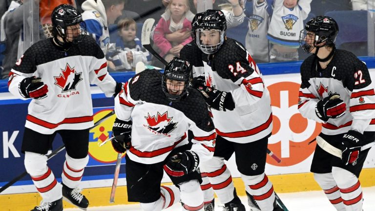 Gavin McKenna, centre, of Canada celebrates his 3-3 equalizer on power play during the 2024 IIHF ice hockey U18 world championships final match between the United States and Canada in Espoo, Finland, Sunday, May 5, 2024. (Jussi Nukari/Lehtikuva via AP)