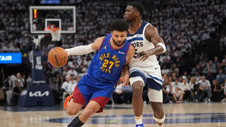 Denver Nuggets guard Jamal Murray (27) works toward the basket as Minnesota Timberwolves guard Anthony Edwards defends during the first half of Game 3 of an NBA basketball second-round playoff series Friday, May 10, 2024, in Minneapolis. (Abbie Parr/AP)