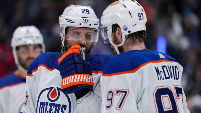 Edmonton Oilers' Leon Draisaitl, back left, and Connor McDavid talk before a faceoff against the Vancouver Canucks during the second period in Game 5 of an NHL hockey Stanley Cup second-round playoff series, in Vancouver, on Thursday, May 16, 2024. (Darryl Dyck/CP)