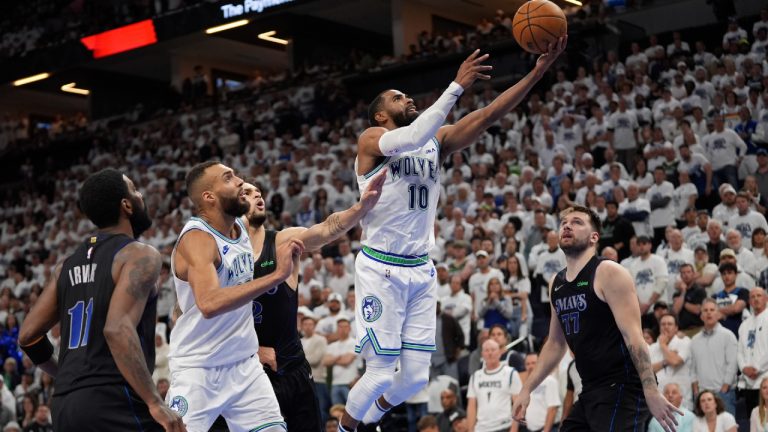 Minnesota Timberwolves guard Mike Conley (10) shoots over Dallas Mavericks guard Luka Doncic (77) during the second half of Game 2 of the NBA basketball Western Conference finals, Friday, May 24, 2024, in Minneapolis. (Abbie Parr/AP)