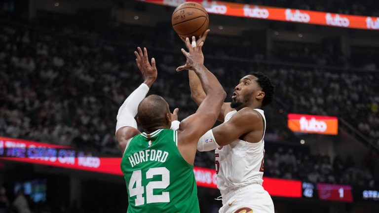 Cleveland Cavaliers guard Donovan Mitchell, right, shoots over Boston Celtics center Al Horford (42) during the first half of Game 3 of an NBA basketball second-round playoff series Saturday, May 11, 2024, in Cleveland. (Sue Ogrocki/AP)