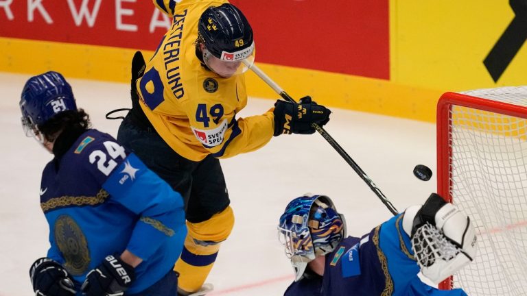 Kazakhstan's goalkeeper Nikita Boyarkin, right, makes a save in front of Sweden's Fabian Zetterlund, centre, during the preliminary round match between Kazakhstan and Sweden at the Ice Hockey World Championships in Ostrava, Czech Republic, Thursday, May 16, 2024. (Darko Vojinovic/AP)