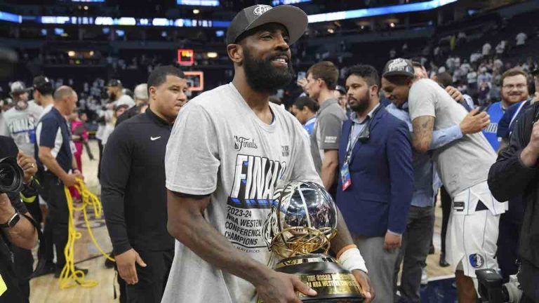 Dallas Mavericks guard Kyrie Irving holds the Western Conference Trophy after Game 5 of the Western Conference finals in the NBA basketball playoffs against the Minnesota Timberwolves, Thursday, May 30, 2024, in Minneapolis. The Mavericks won 124-103, taking the series 4-1 and moving on to the NBA Finals. (Abbie Parr/AP)