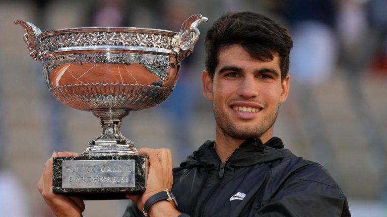 Winner Spain's Carlos Alcaraz celebrates with the trophy as he won the men's final match of the French Open tennis tournament against Germany's Alexander Zverev at the Roland Garros stadium in Paris, Sunday, June 9, 2024. (AP/Thibault Camus)