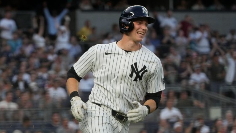 New York Yankees' Ben Rice smiles as he runs to first base after getting a hit in his first MLB game, June 18, 2024. (AP Photo/Pamela Smith)