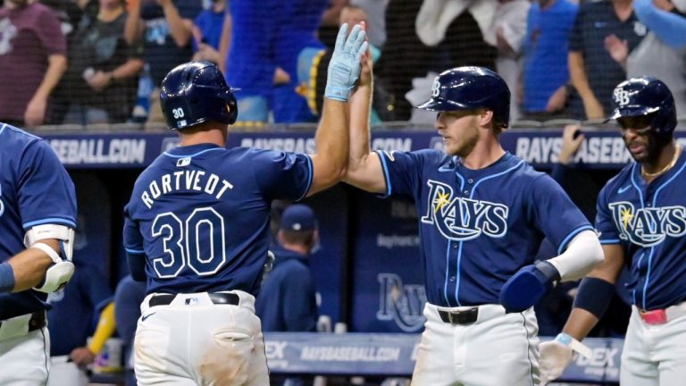 Tampa Bay Rays' Taylor Walls, and Yandy Diaz, congratulate Ben Rortvedt for his two-run home run against the Seattle Mariners, June 25, 2024. (AP Photo/Steve Nesius)