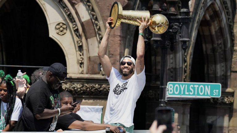 Boston Celtics' Jayson Tatum celebrates the team's NBA basketball championship during a duck boat parade Friday, June 21, 2024, in Boston. (Michael Dwyer/AP)