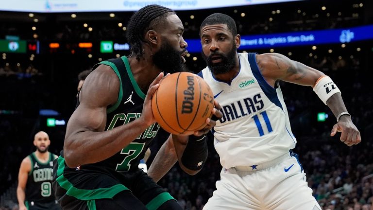 Boston Celtics' Jaylen Brown (7) looks to move against Dallas Mavericks' Kyrie Irving (11) during the first half of an NBA basketball game. (Michael Dwyer/AP)