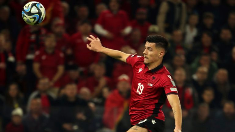 Albania's Mirlind Daku, left, goes for the ball  during the Euro 2024 group E qualifying soccer match in Tirana, Albania, Monday, Nov. 20, 2023. (Armando Babani/AP) 