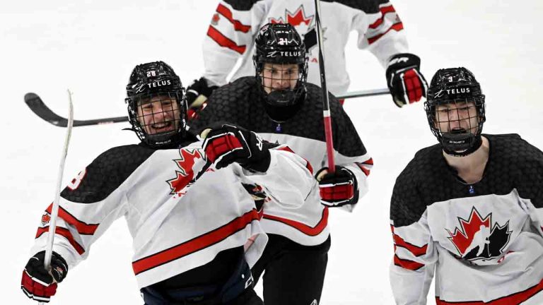 Goal scorer Cole Beaudoin, left, Ryder Ritchie and Matthew Schaefer of Canada celebrate team's 3-4 power play goal during the 2024 IIHF ice hockey U18 world championships final match between the United States and Canada in Espoo, Finland, Sunday, May 5, 2024. (Jussi Nukari/Lehtikuva via AP)