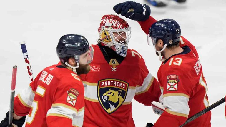 Florida Panthers centre Sam Reinhart (13) celebrates with goaltender Sergei Bobrovsky, centre, and defenceman Aaron Ekblad (5) after Reinhart scored during an overtime period of Game 4 during the Eastern Conference finals of the NHL hockey Stanley Cup playoffs to beat the New York Rangers, Tuesday, May 28, 2024, in Sunrise, Fla. (Wilfredo Lee/AP)