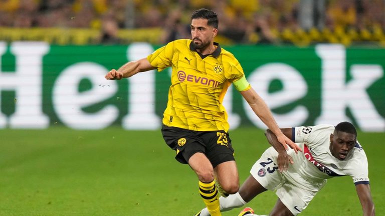 Dortmund's Emre Can is challenged by PSG's Randal Kolo Muani, right, during the Champions League semifinal first leg soccer match between Borussia Dortmund and Paris Saint-Germain at the Signal-Iduna Park stadium in Dortmund, Germany, Wednesday, May 1, 2024. (Matthias Schrader/AP)