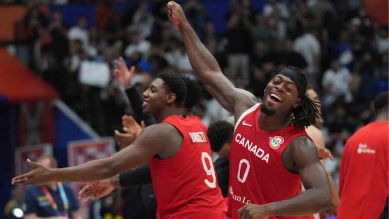 Canada guard Luguentz Dort and forward RJ Barrett celebrate after winning the Basketball World Cup second round match between Spain and Canada at the Indonesia Arena stadium in Jakarta, Indonesia, Sunday, Sept. 3, 2023. (Tatan Syuflana/AP Photo)