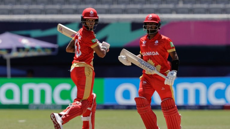 Canada's Nicholas Kirton, left, and partner Shreyas Movva run between wickets to score against Ireland during an ICC Men's T20 World Cup cricket match at the Nassau County International Cricket Stadium in Westbury, New York, Friday, June 7, 2024. (AP/Adam Hunger)