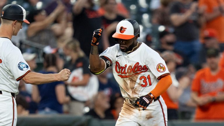 Baltimore Orioles' Cedric Mullins celebrates a home run with third base coach Tony Mansolino during the seventh inning of a game against the Cleveland Guardians, June 26, 2024. (AP Photo/Stephanie Scarbrough)