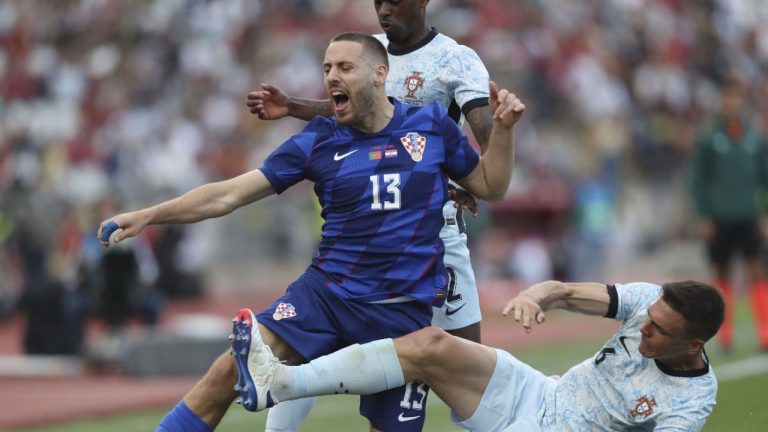 Croatia's Nikola Vlasic is tackled by Portugal's Joao Palhinha during an international friendly soccer match between Portugal and Croatia at the National Stadium in Oeiras, outside Lisbon, Saturday, June 8, 2024. (Pedro Rocha/AP Photo)
