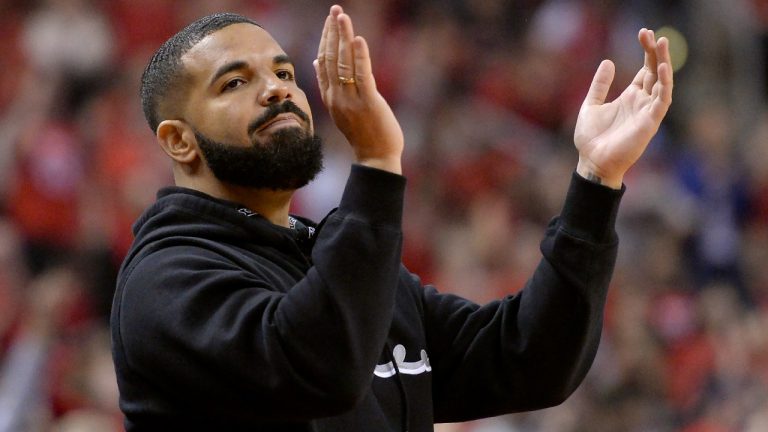 Toronto-born performer Aubrey "Drake" Graham cheers from courtside during first half NBA Eastern Conference finals action between the Toronto Raptors and the Milwaukee Bucks, in Toronto on Saturday, May 25, 2019. (Nathan Denette/CP)