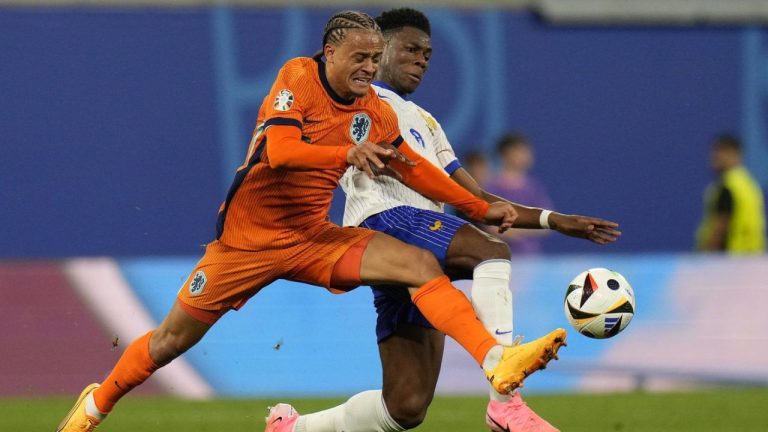 Xavi Simons of the Netherlands is challenged by Aurelien Tchouameni of France during the Group D match between the Netherlands and France at the Euro 2024 soccer tournament in Leipzig, Germany, Friday, June 21, 2024. (Hassan Ammar/AP Photo)
