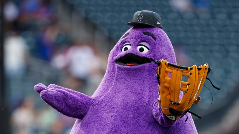 The McDonald's Grimace throws out the first pitch before a game between the Miami Marlins and New York Mets, June 12, 2024. (AP Photo/Rich Schultz)