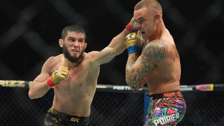 Islam Makhachev, left, punches Dustin Poirier during the second round of a lightweight title bout at the UFC 302 mixed martial arts event early Sunday, June 2, 2024, in Newark, N.J. Makhachev won the bout. (AP Photo/Frank Franklin II)