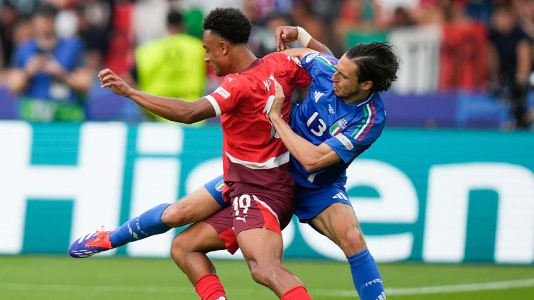 Italy's Matteo Darmian, right, defends on Switzerland's Dan Ndoye during a round of sixteen match between Switzerland and Italy at the Euro 2024 soccer tournament in Berlin, Germany, Saturday, June 29, 2024. (Matthias Schrader/AP)