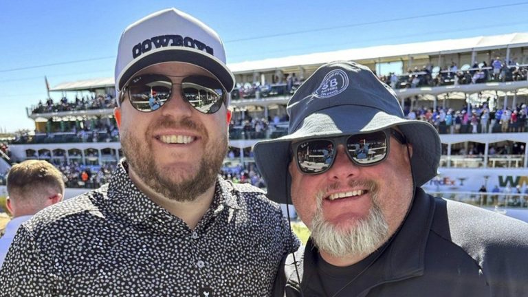 Jeremy Malone, left, and Judson Dymond, the co-owners of The Sportsbook Bar & Grill in Greenwood, Colo., pose for a photo. (Jeremy Malone via AP)