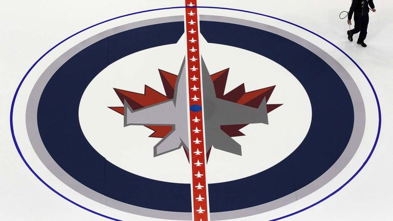 Winnipeg Jets staff lay down the Jet logo at centre ice of MTS Centre in Winnipeg on Tuesday, January 8, 2013. (John Woods/CP)