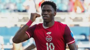 Canada's Jonathan David celebrates scoring his side's opening goal against Peru during a Copa America Group A soccer match in Kansas City, Kan., Tuesday, June 25, 2024. (AP Photo/Ed Zurga)