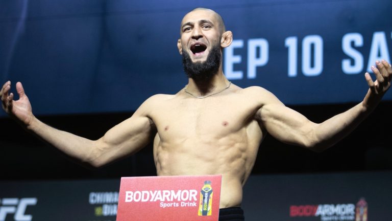 UFC fighter Khamzat Chimaev poses on the scale during a ceremonial weigh-in. (Steve Marcus/Las Vegas Sun via AP)