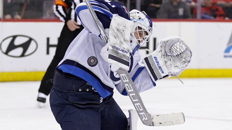 Winnipeg Jets goaltender Laurent Brossoit makes a save against the New Jersey Devils during the second period of an NHL hockey game Thursday, March 21, 2024, in Newark, N.J. (AP Photo/Adam Hunger)